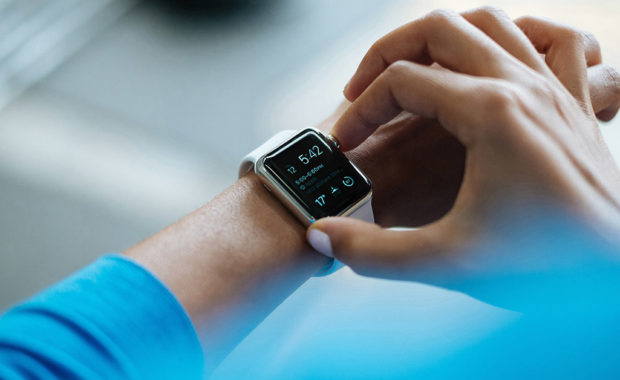 Photo of person adjusting smartwatch on wrist