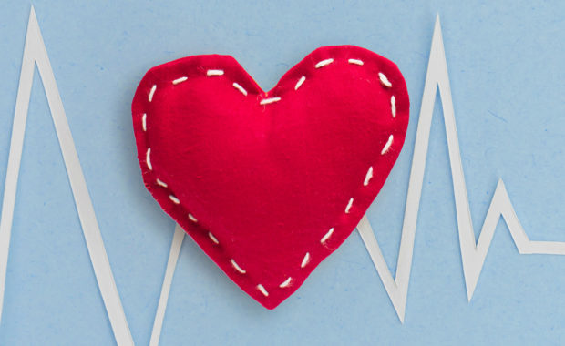 homemade red felt heart on blue background